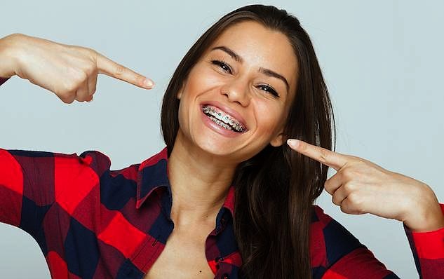 Confident adult professional smiling after discreet orthodontic treatment