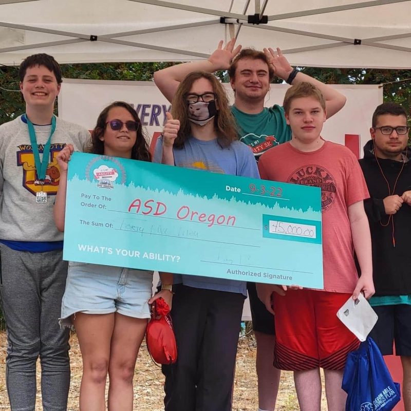 Group holding large check for ASD Oregon event