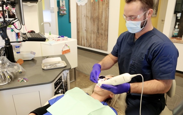 Dentist performing dental procedure on female patient