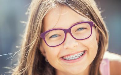 Smiling girl with glasses and braces