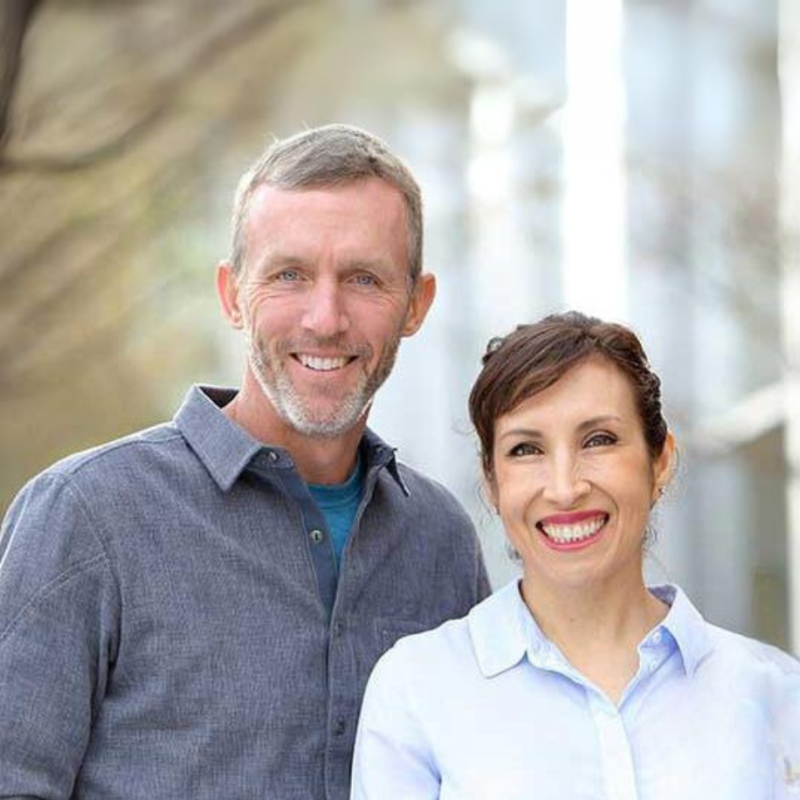 Smiling man and woman standing together outdoors