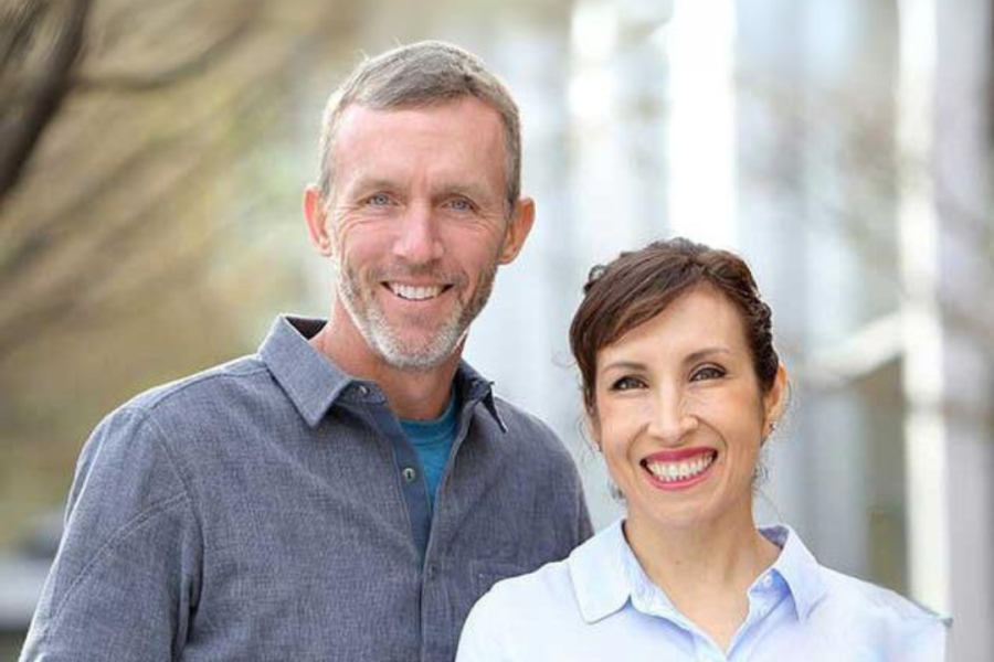 Smiling man and woman standing together outdoors