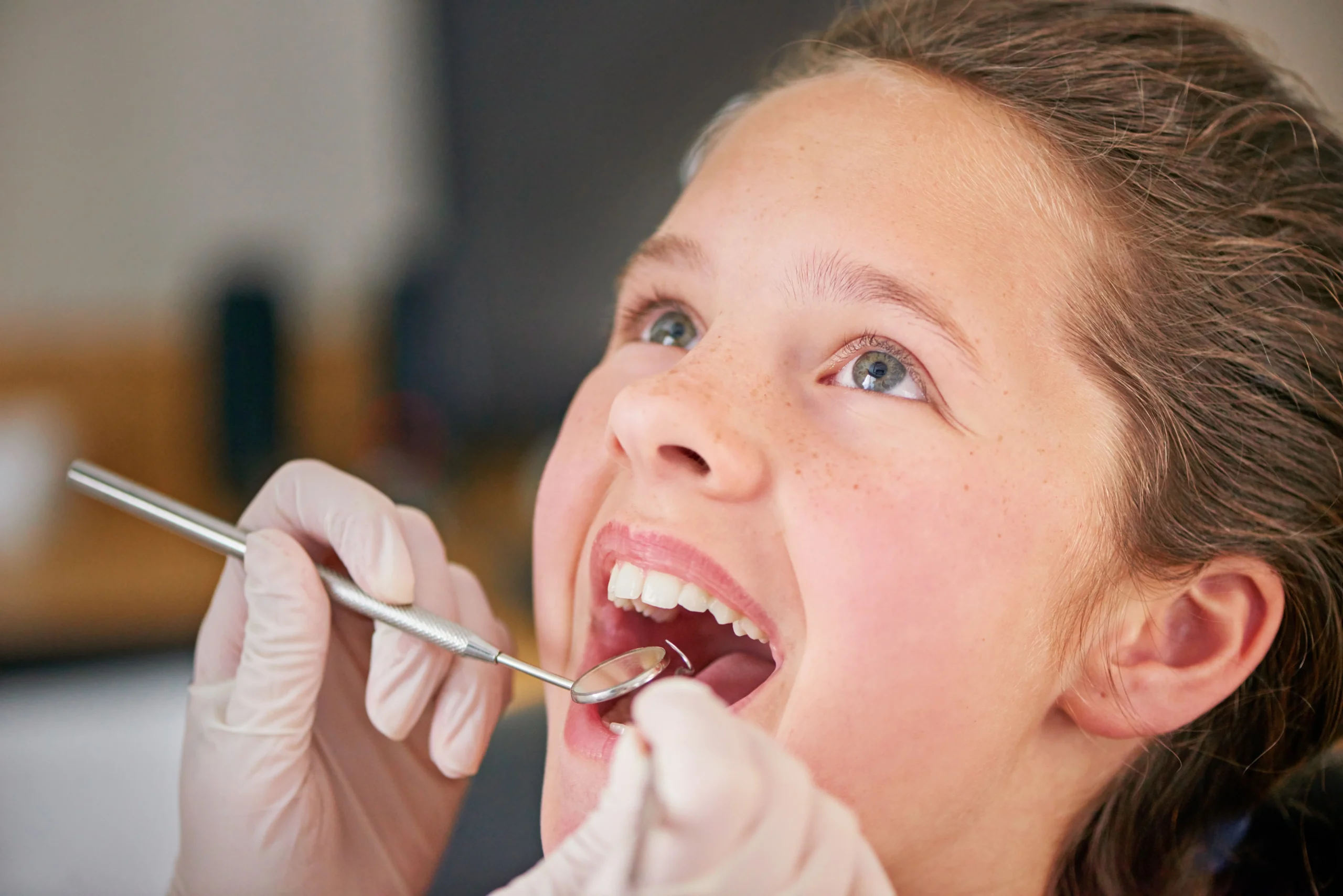 Young girl receiving dental examination