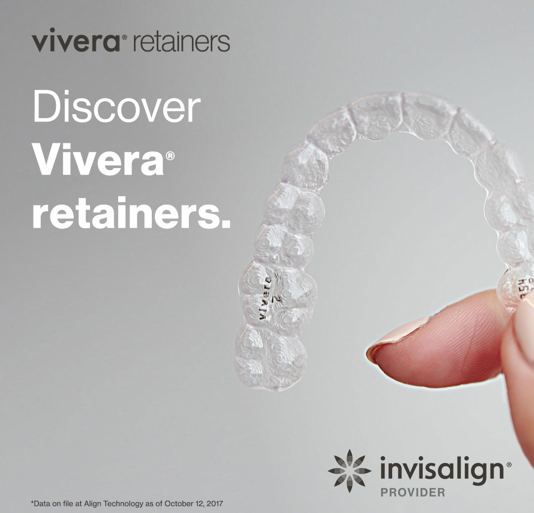 Fingers holding transparent Vivera retainer by Invisalign.